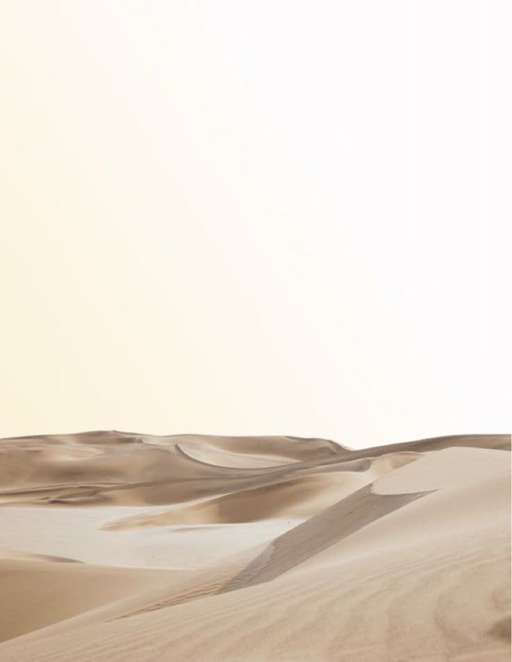 Soft, pale sand dunes under a bright sky